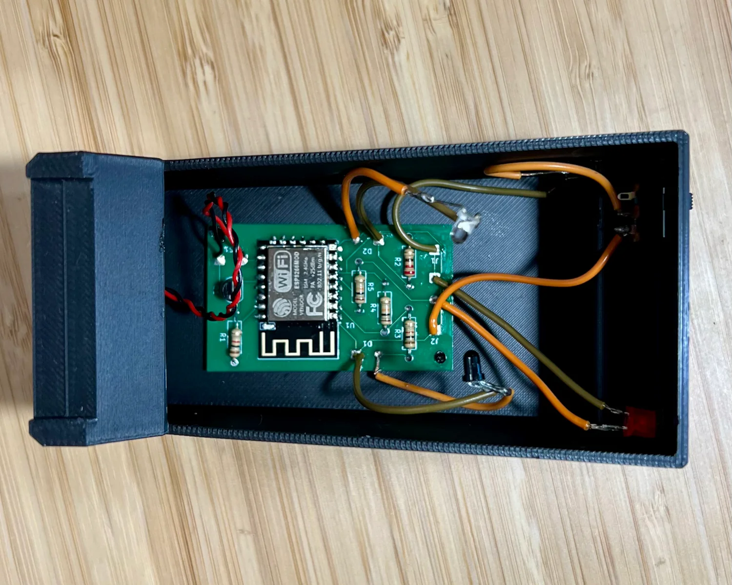 A top down view of a completed PCB installed inside the 3D-printed case.