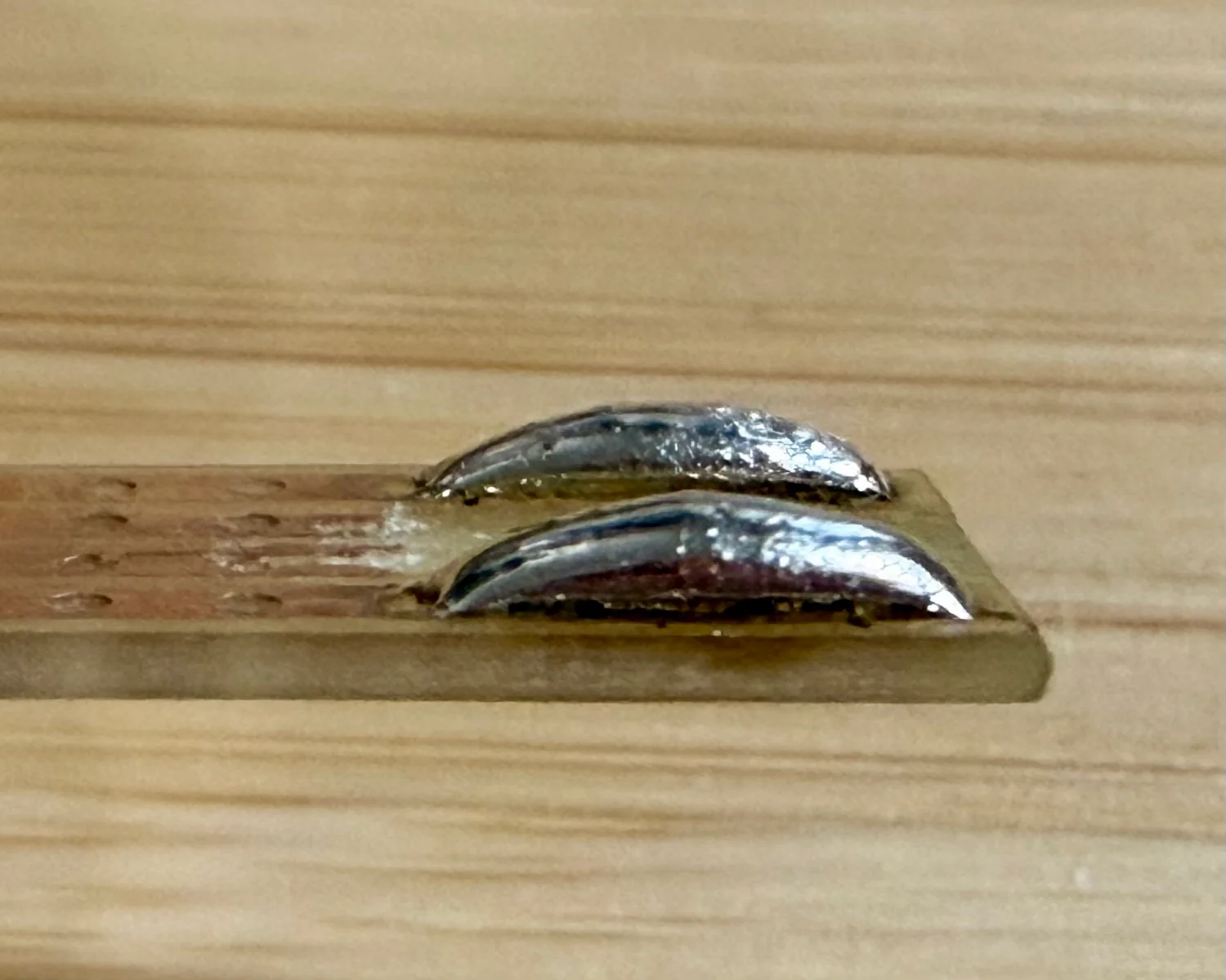 Side-on view of the cheap and dirty supply's solder blobs.