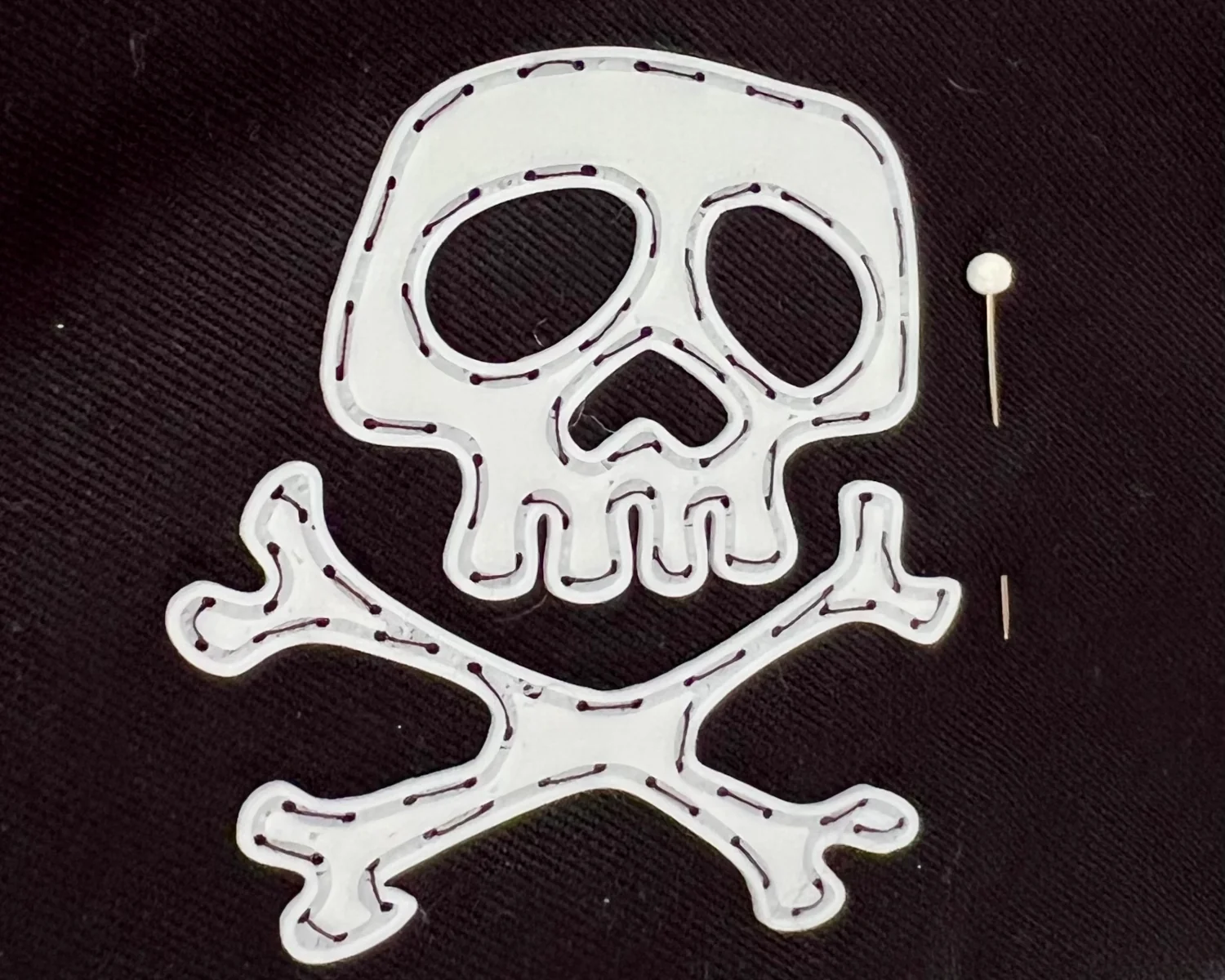 A close-up of the badge sewed on to the hat.