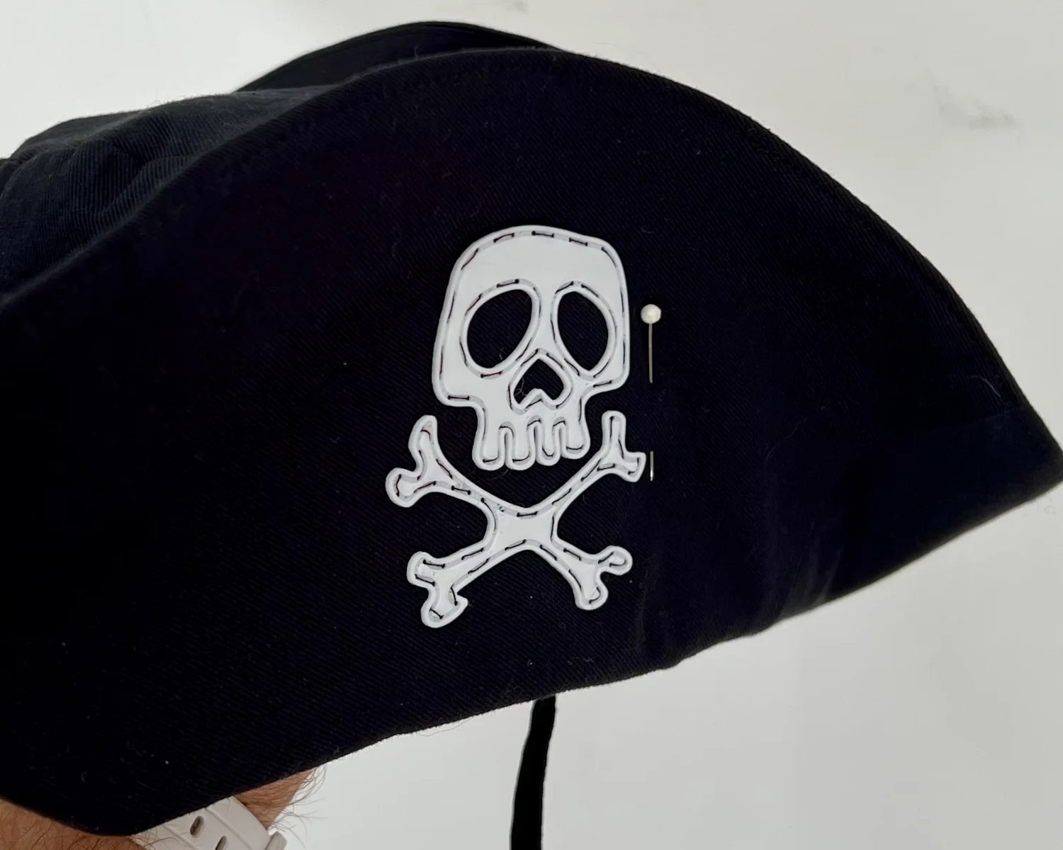 A photo from further away of the badge sewed on to the hat.