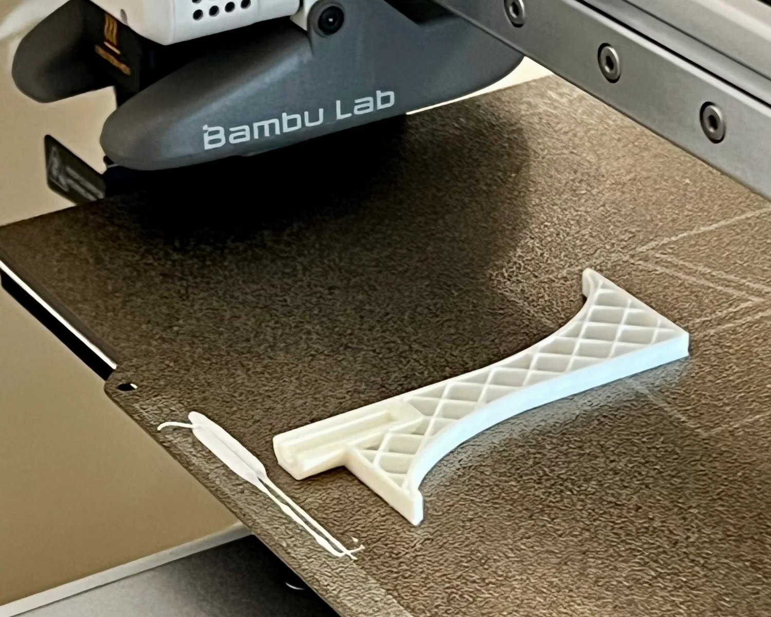 A helmet hook midway through the 3D printing process.