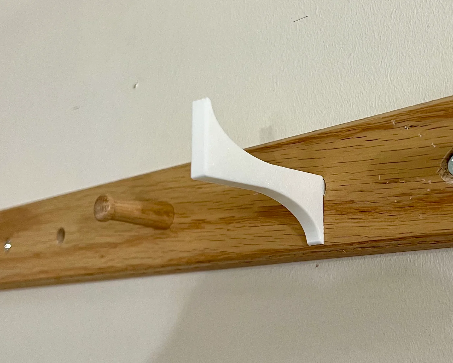 A 3D printed helmet hook fitted to an IKEA HÖVOLM.