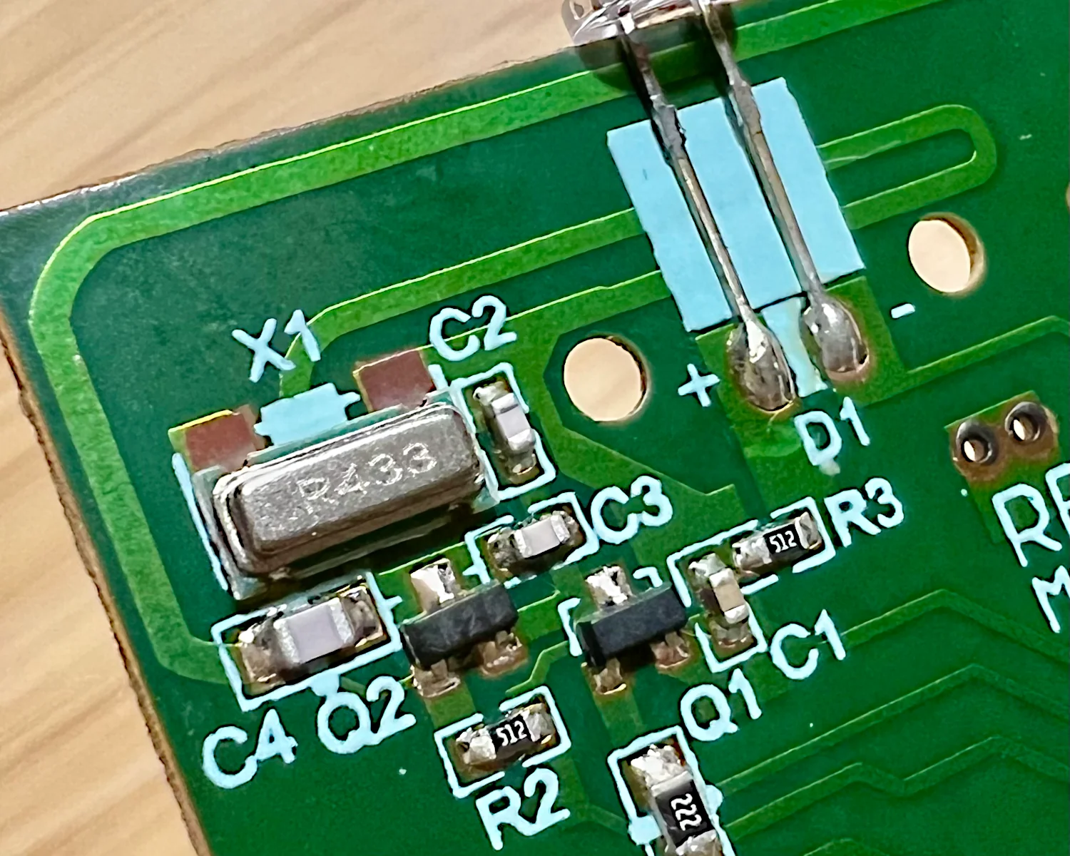 The PCB trace antenna and crystal on the remote control's PCB.