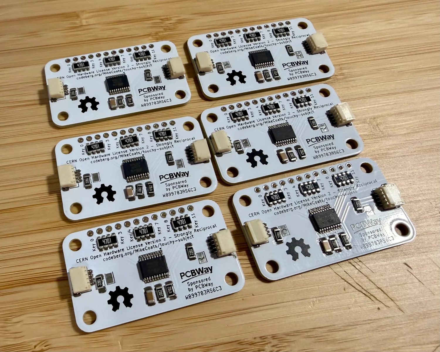 6 Touchy Subject boards, solder paste applied and components placed.