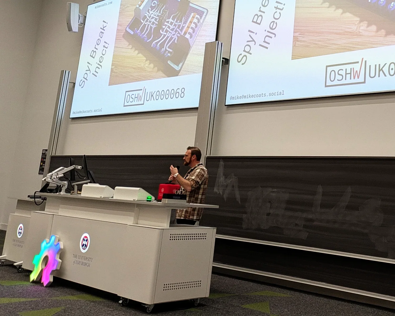 Me, standing in front of two projector screens, delivering my talk.