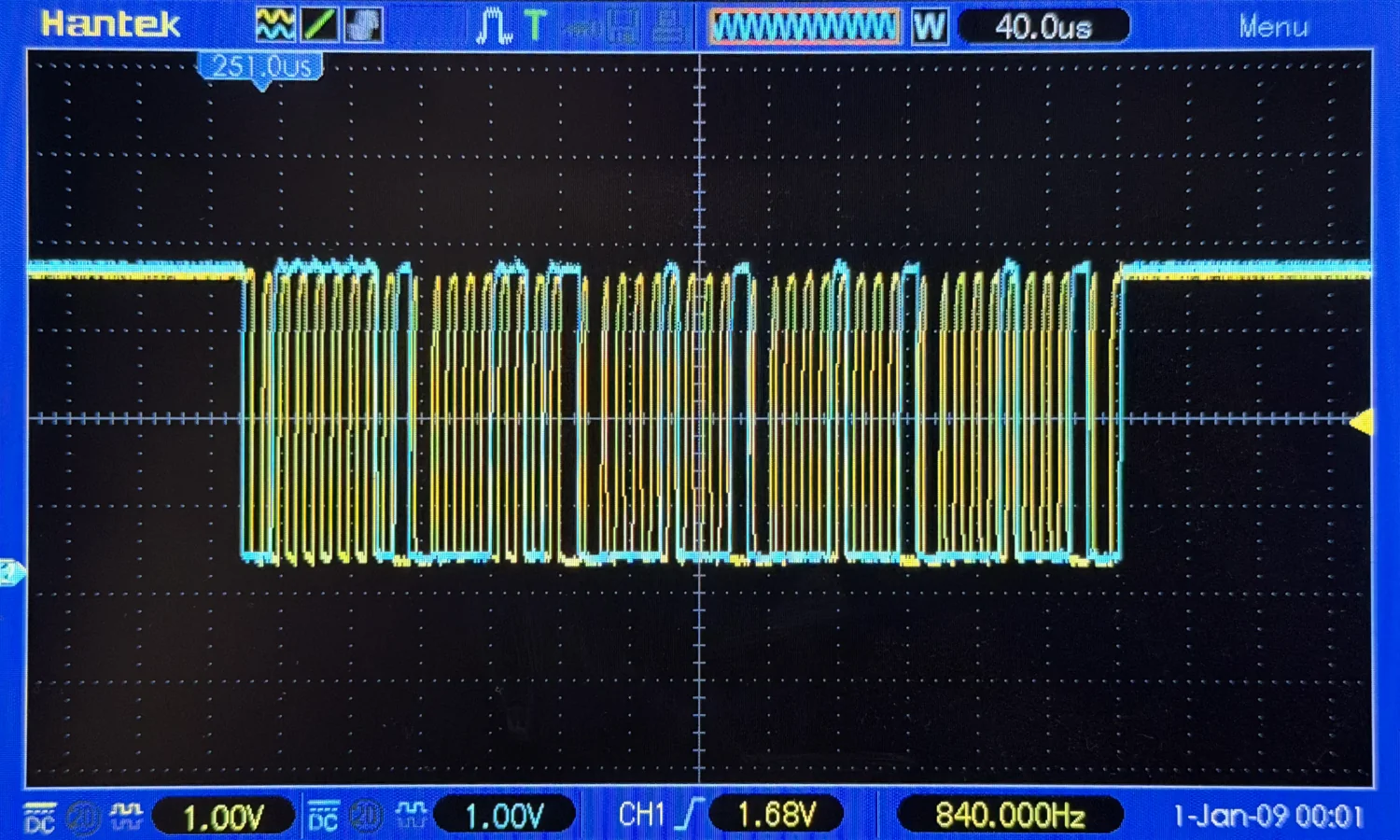 A photo of an oscilloscope, zoomed out, showing clocking and data traces.