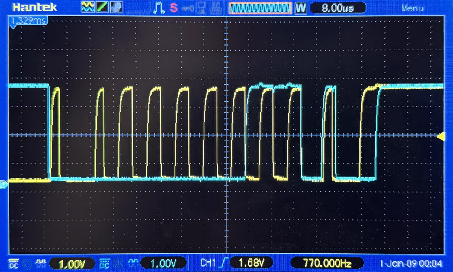 A photo of an oscilloscope, zoomed in, showing clocking and data traces.