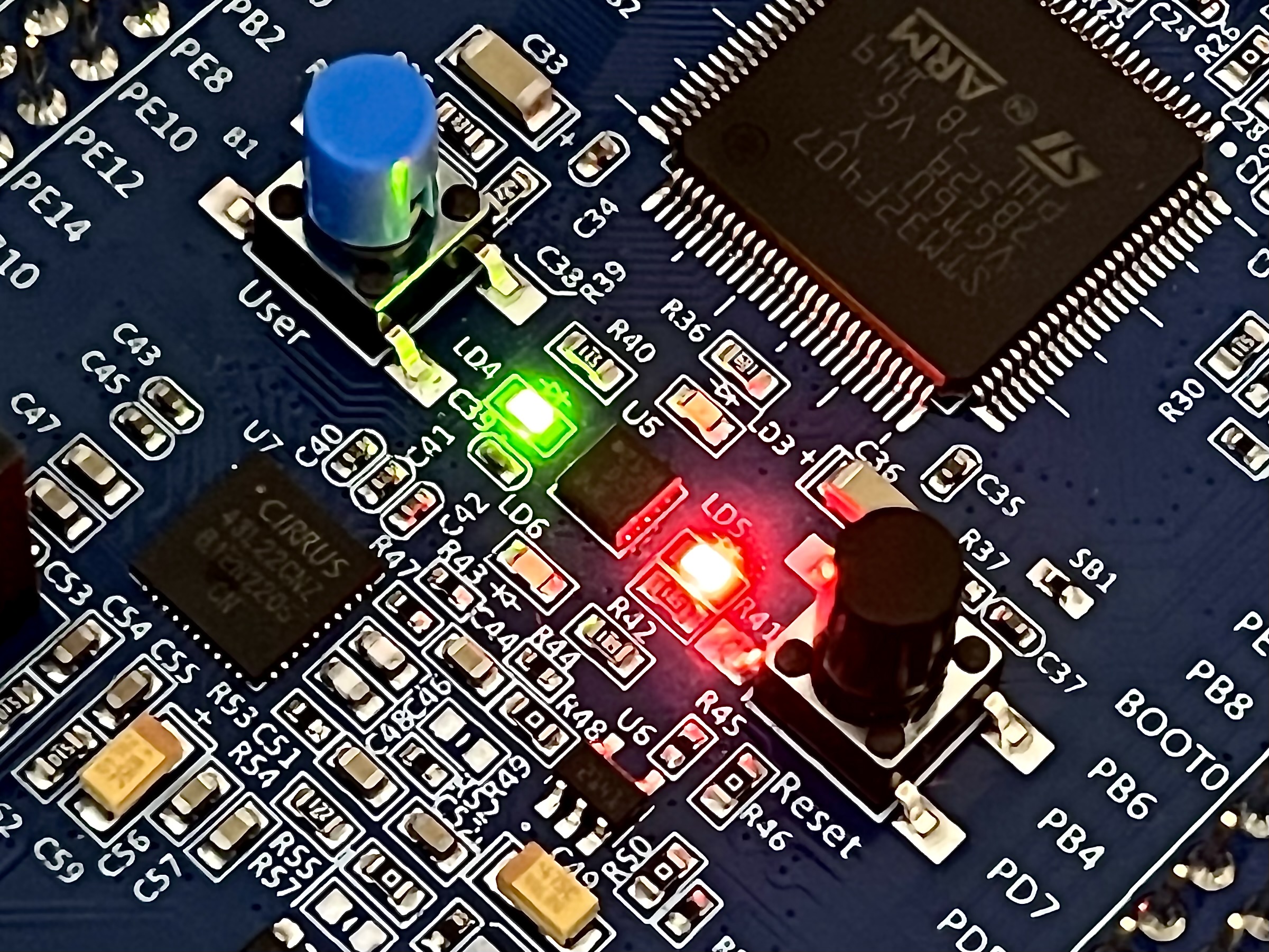 A photograph of an STM32F4 dev board with the east and west LEDs illuminated.